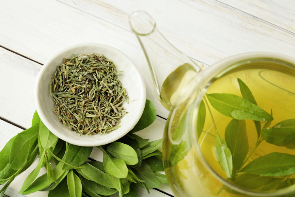 healthy green tea cup with tea leaves ; 