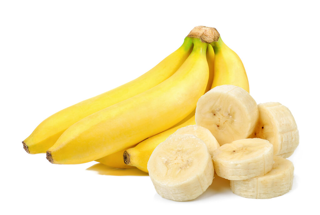 Bunch of bananas, one of which has been sliced