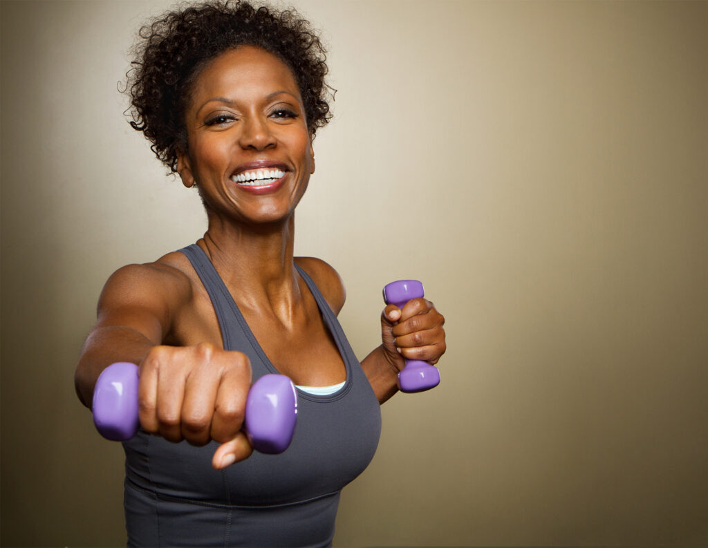 African American woman lifting weights.