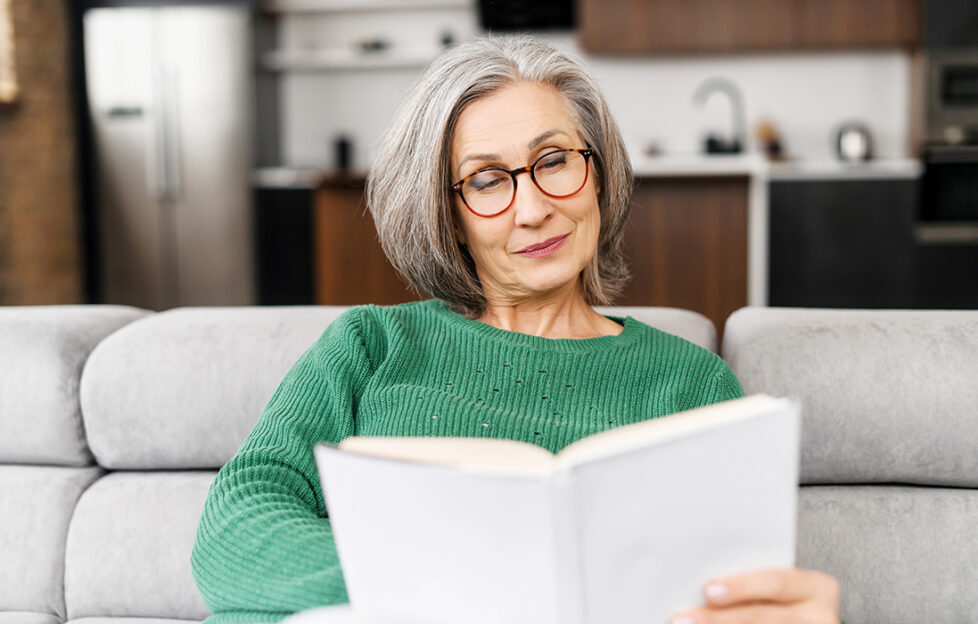 Lady reading book indoors Pic: Shutterstock