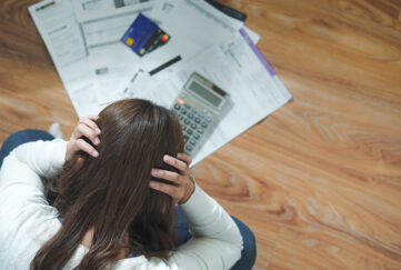 money worries, woman looking at bills