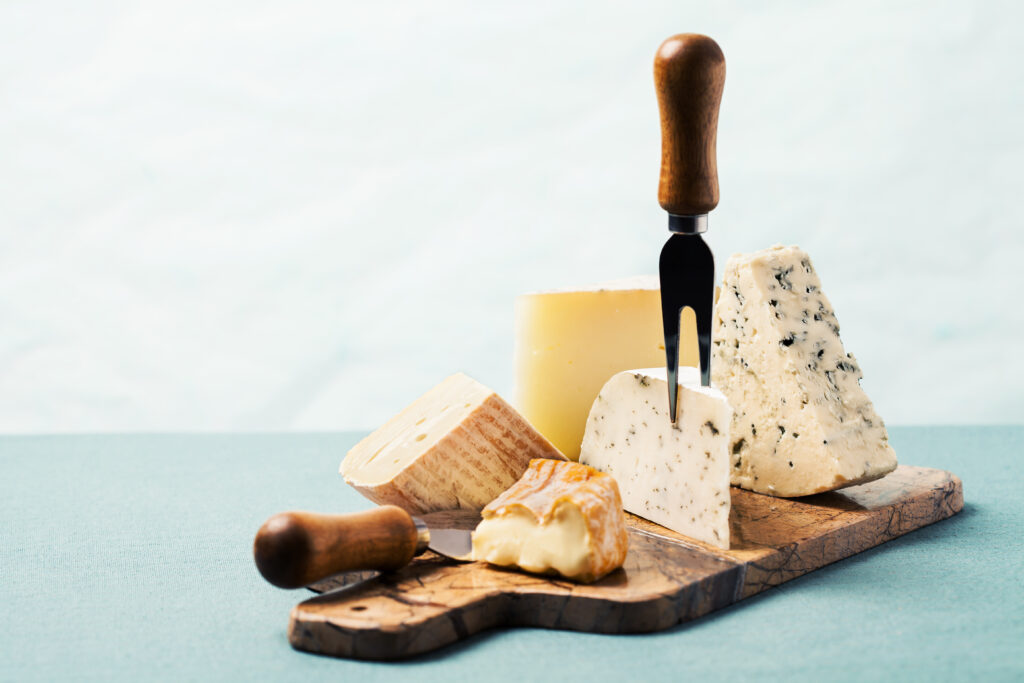 Cheese board: variety of cheeses on marble serving board;