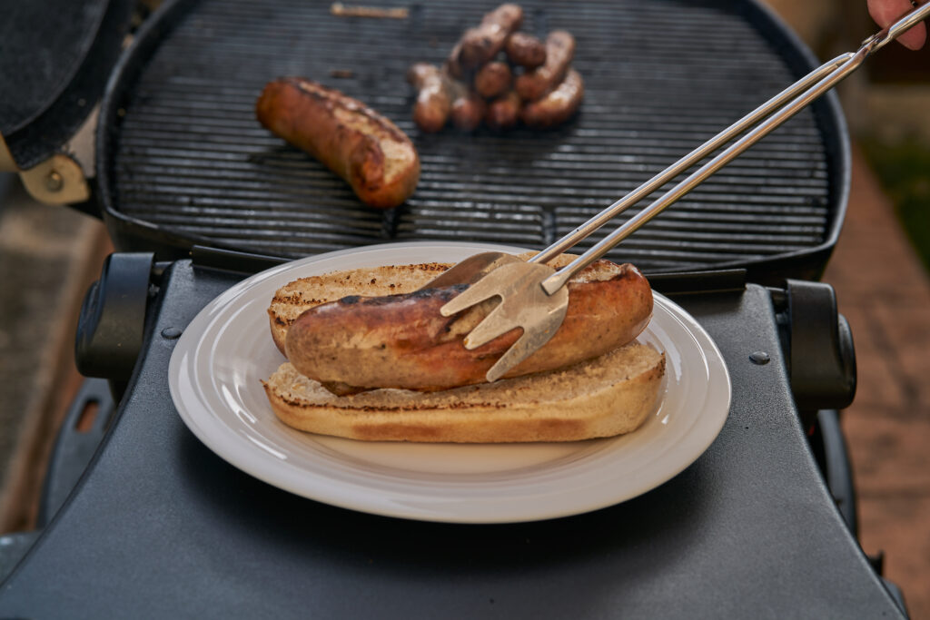Grilled Sausage on the flaming Grill. BBQ. 
