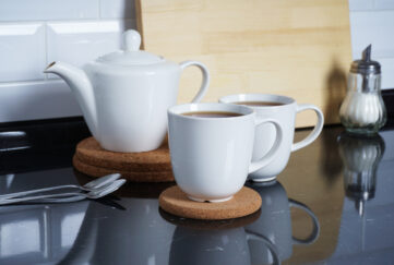 Kitchen interier. Brewed tea in white mugs on the kitchen table. Comfort and warmth at home. Tea party;
