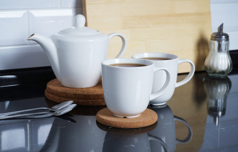 Kitchen interier. Brewed tea in white mugs on the kitchen table. Comfort and warmth at home. Tea party;