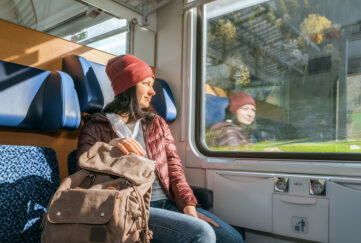 female backpacker on a train