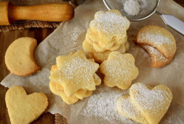 Moon and star shaped golden biscuits, icing sugar sprinkled over