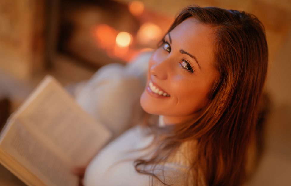 Lady reading at fire Pic: Shutterstock