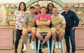 Image from Bake Off 2023 final. From left to right presenters (standing): Noel Fielding, Prue Leith and Paul Hollywood. From left to right seated finalists: Matty, Josh and Dan.