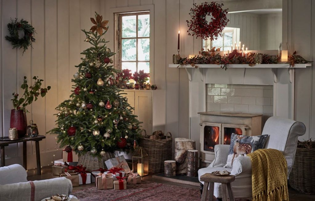 Real Christmas tree in beautifully decorated living room