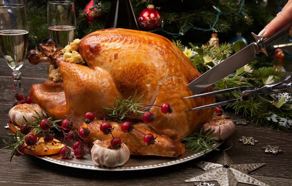 Carving a turkey garnished with cranberries Pic: Shutterstock