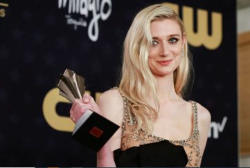 Elizabeth Debicki has won the best supporting actress in a drama series, for her role in The Crown. Image shows the actress holding up the award on the red carpet, she's wearing a sparkly gown and now has long blonde hair.