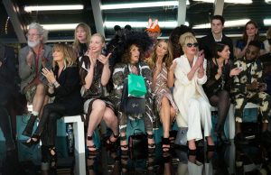 5 reasons we love lulu! Image shows Sadie Frost, Lulu, Joanna Lumley, Jennifer Saunders, Abbey Clancy, Tinie Tempah, and Gwendoline Christie in Absolutely Fabulous: The Movie (2016). They are all sitting front row at a mock fashion show.