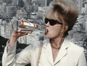 Gif featuring Patsy from Ab Fab downing a bottle of vodka with a city backdrop.