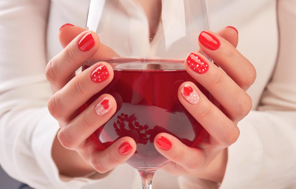 Menus Might Scrap Your Large Glass Of Wine! Image feature a women with polkat dot painted nails (red and white varnish) cupping a large glass of red wine.