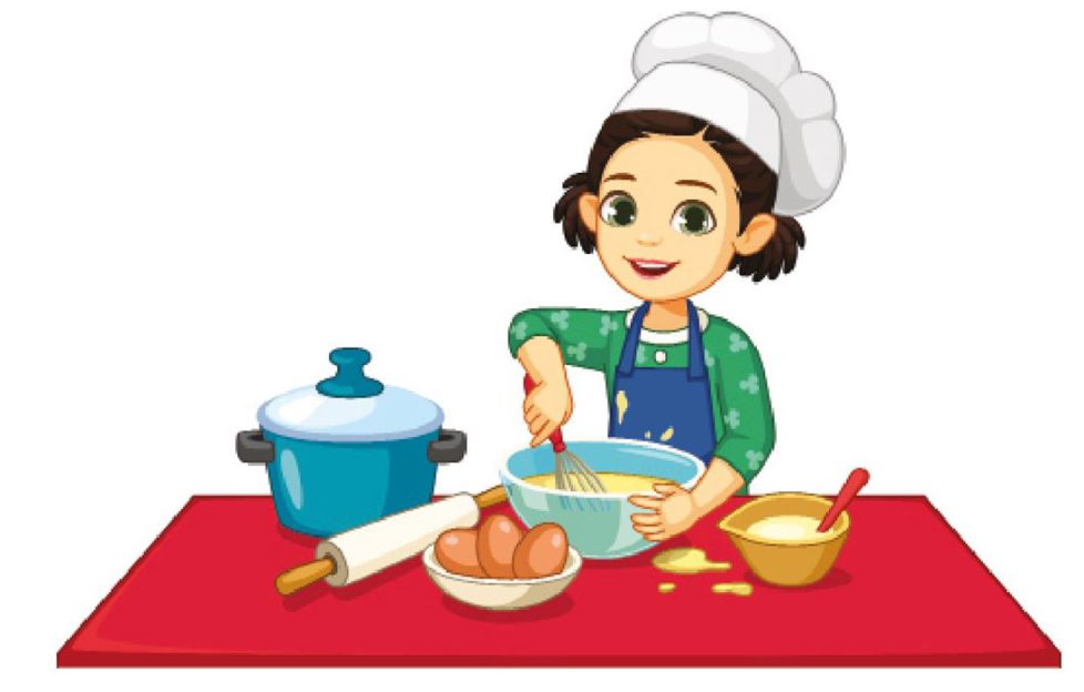 Child with bright apron baking cakes