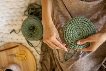 Woman crocheting bag.