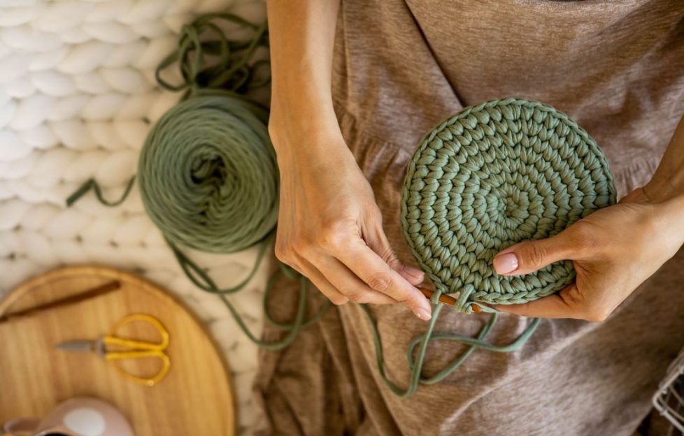 Woman crocheting bag.