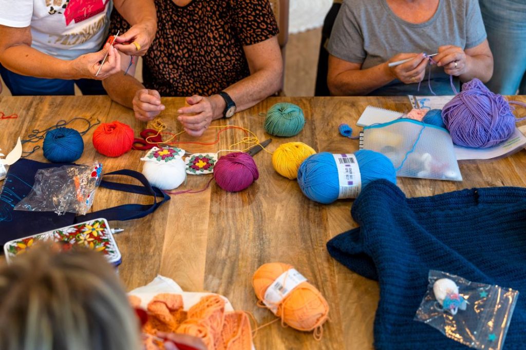 Table of people crocheting.