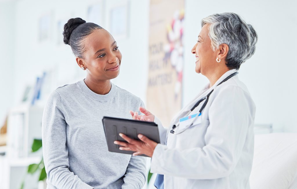 Lady receiving test results from a female doctor