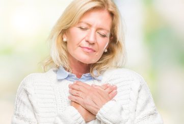 Woman with her hands on her chest