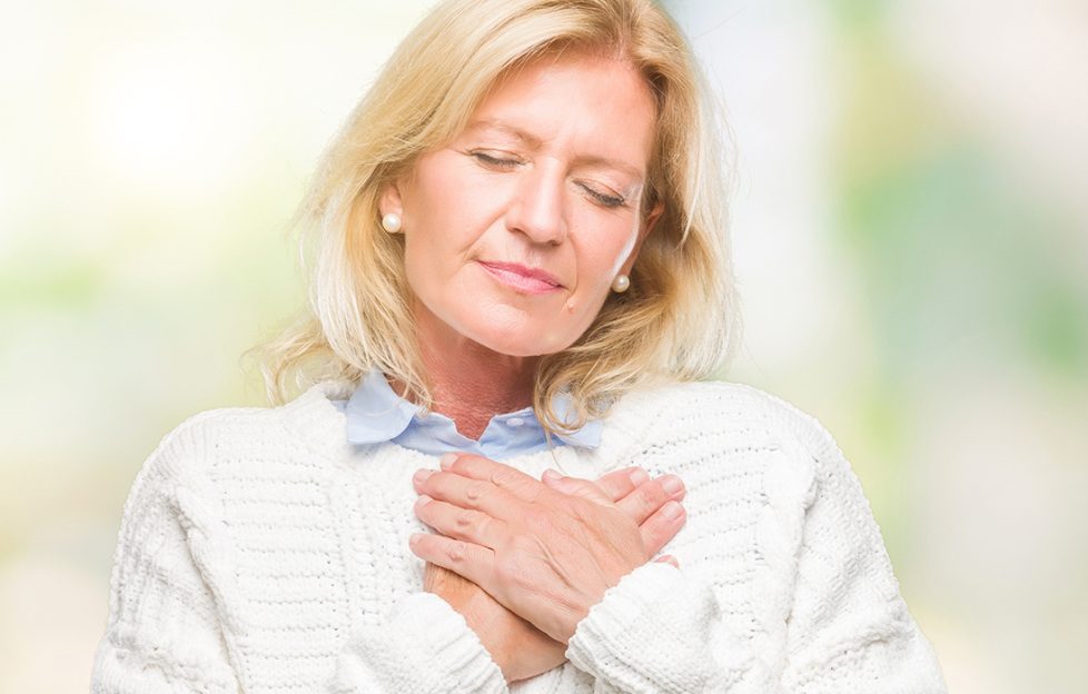 Woman with her hands on her chest