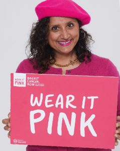 Lady holding a wear it pink sign