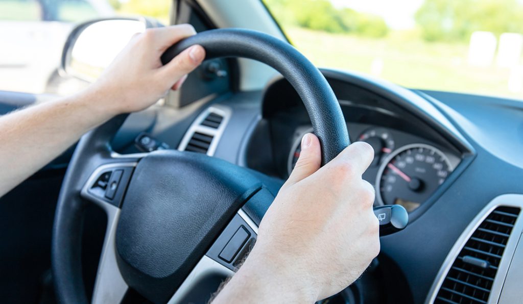 Hands on a steering wheel