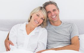 Happy older couple in bed