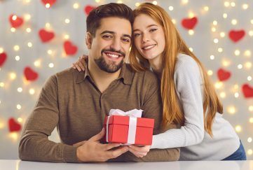 A lady giving a man a Valentine's Day Gift