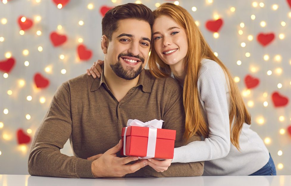 A lady giving a man a Valentine's Day Gift