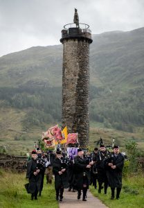 Lochaber Pipe Band opening the 2017 Glenfinnan Gathering with the 1745 monument in the background. Photograph: Abrightside Photography. F33 Glenfinnan Games 07JP.