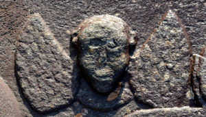 One of two gruesome winged angels of death carved on the lid of the Rev Archibald Malcolm's tomb, Kilmartin. Photograph: Iain Thornber