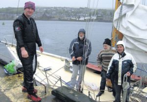 In 2011: Diver Robert Lamont, far left, removed the damaged rudder from Sceptre when she was safely back at Campbeltown Harbour. Also pictured, from left: skipper Tom Smith, Neil Blair and Roger Finbow.