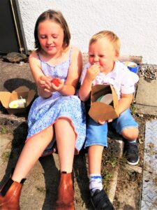Lochlann and Ella Bevis enjoying tasty treats at the fun day on Seil