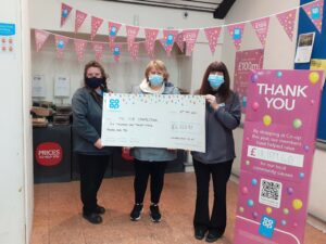 Co-op staff present Mandy Robertson of The Hub with the charity's cheque.