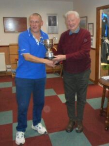 Sandy Watson, right, presents the Heidbanger Cup to competition winner Neil Brodie.